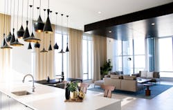 Black pendant task lighting adds a sculptural feel to the open-plan kitchen/living space Black pendant task lighting adds a sculptural feel to the open-plan kitchen/living space