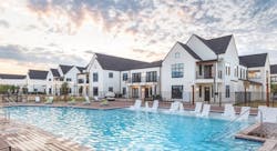 Hermosa Village outdoor pool surrounded by multifamily rental buildings in modern farmhouse style Hermosa Village outdoor pool surrounded by multifamily rental buildings in modern farmhouse style