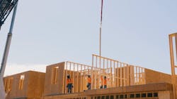 Crane lowers prefab wall panels for second floor into place on the Agorus and Hallmark Communities' Daybreak project Crane lowers prefab wall panels for second floor into place on the Agorus and Hallmark Communities' Daybreak project