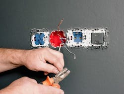An Electrician Using Pliers to Repair the AC Power Plugs and Sockets An Electrician Using Pliers to Repair the AC Power Plugs and Sockets