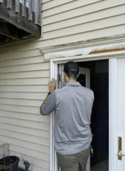 Person shimming door frame Person shimming door frame