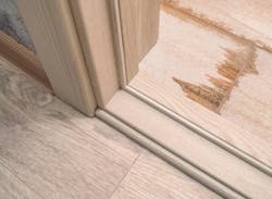 Moisture damaged hardwood floor inside door frame Moisture damaged hardwood floor inside door frame