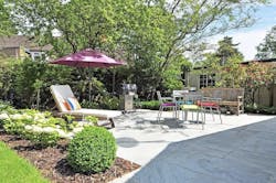 Hardscaped patio area with umbrella and seating Hardscaped patio area with umbrella and seating