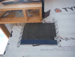 Taping exposed building wrap to flashing Taping exposed building wrap to flashing