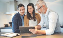 Homeowners in the kitchen with the site supervisor for the project Homeowners in the kitchen with the site supervisor for the project
