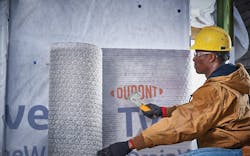 Man Installs Du Pont™ Tyvek® Drain Vent™ Rainscreen Man Installs Du Pont™ Tyvek® Drain Vent™ Rainscreen