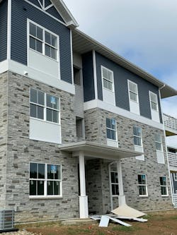Versetta Stone siding and blue vinyl siding to lend a single-family feel that elevates this garden-style apartment complex Versetta Stone siding and blue vinyl siding to lend a single-family feel that elevates this garden-style apartment complex