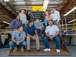 Teleo company employees playful on construction equipment Teleo company employees playful on construction equipment