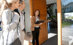 Real estate agent showing couple a new home for sale Real estate agent showing couple a new home for sale