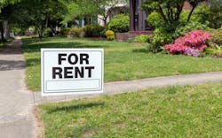 A 'For Rent' sign posted in a front yard A 'For Rent' sign posted in a front yard