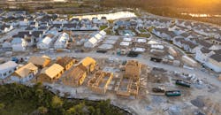 Aerial view of a community of new single-family homes at different stages of construction Aerial view of a community of new single-family homes at different stages of construction