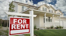A single-family home that has a red 'For Rent' sign in the front yard A single-family home that has a red 'For Rent' sign in the front yard