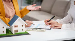 A homeowner fills out a loan application