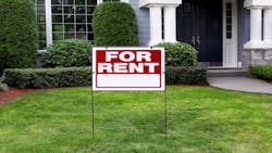 A blue single-family home with red 'For Rent' sign in the front yard A blue single-family home with red 'For Rent' sign in the front yard