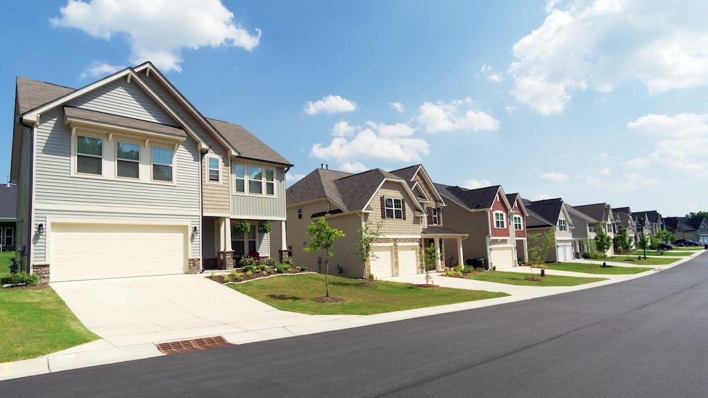 A row of newly built homes in a suburban neighborhood