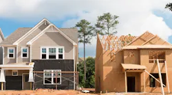 A newly built home sits next to one that is under construction