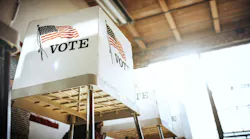 A row of voting booths with American flags on them