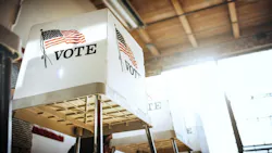A row of voting booths with American flags on them