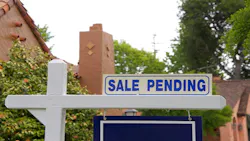 Blue sign in front of a home reading 'sale pending' Blue sign in front of a home reading 'sale pending'