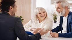 A Baby Boomer couple speaks to a real estate agent about buying a new home where they can age in place. A Baby Boomer couple speaks to a real estate agent about buying a new home where they can age in place.