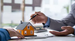 A real estate agent goes over the homebuying process with a potential buyer