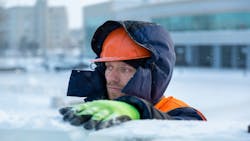 A construction worker bundles up during winter weather A construction worker bundles up during winter weather