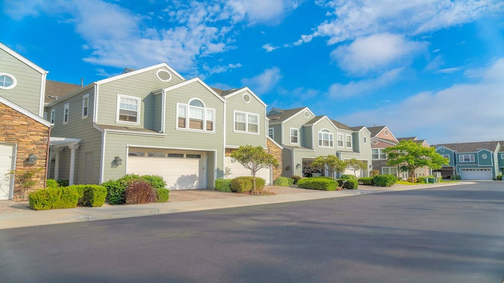 Street view of townhomes with garages