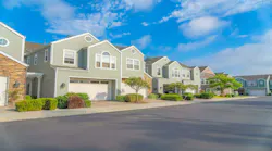 Street view of townhomes with garages