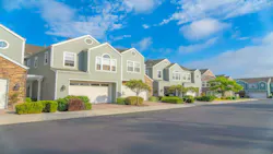 Street view of townhomes with garages