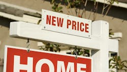 Home for sale sign with 'new price' signage added on top. Home for sale sign with 'new price' signage added on top.
