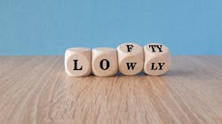 Wooden blocks with 'lowly' letters switching to 'lofty' indicate striving for higher goals. Wooden blocks with 'lowly' letters switching to 'lofty' indicate striving for higher goals.