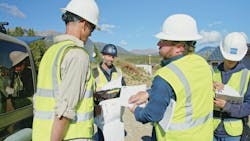 A construction crew discusses potential changes on the jobsite. A construction crew discusses potential changes on the jobsite.