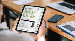 An individual looks over the buyer conversion report on a tablet