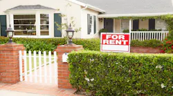 A single-family home with a 'For Rent' sign in the front yard