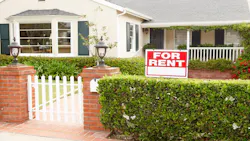 A single-family home with a 'For Rent' sign in the front yard