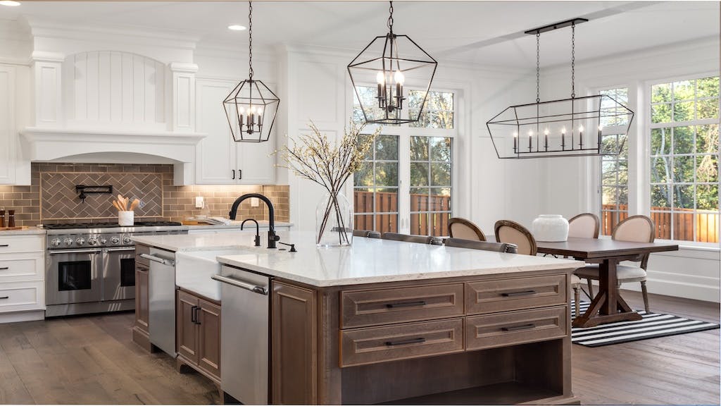 A modern eat-in style kitchen with a large island and wooden cabinetry