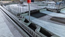 A 3D printer working on creating the walls of a home A 3D printer working on creating the walls of a home