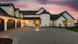 A luxury home with white exterior and expansive driveway A luxury home with white exterior and expansive driveway