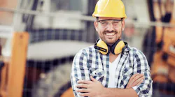 A construction worker in a yellow hard hat on at a jobsite