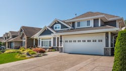 A row of newly constructed homes in a suburban neighborhood A row of newly constructed homes in a suburban neighborhood