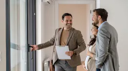 A couple tours a home with a real estate agent