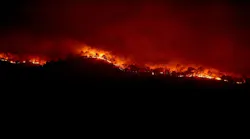 Wildfire burning on a hillside in California