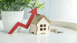 A model home with a red arrow pointing upward, indicating rising costs for homeownership