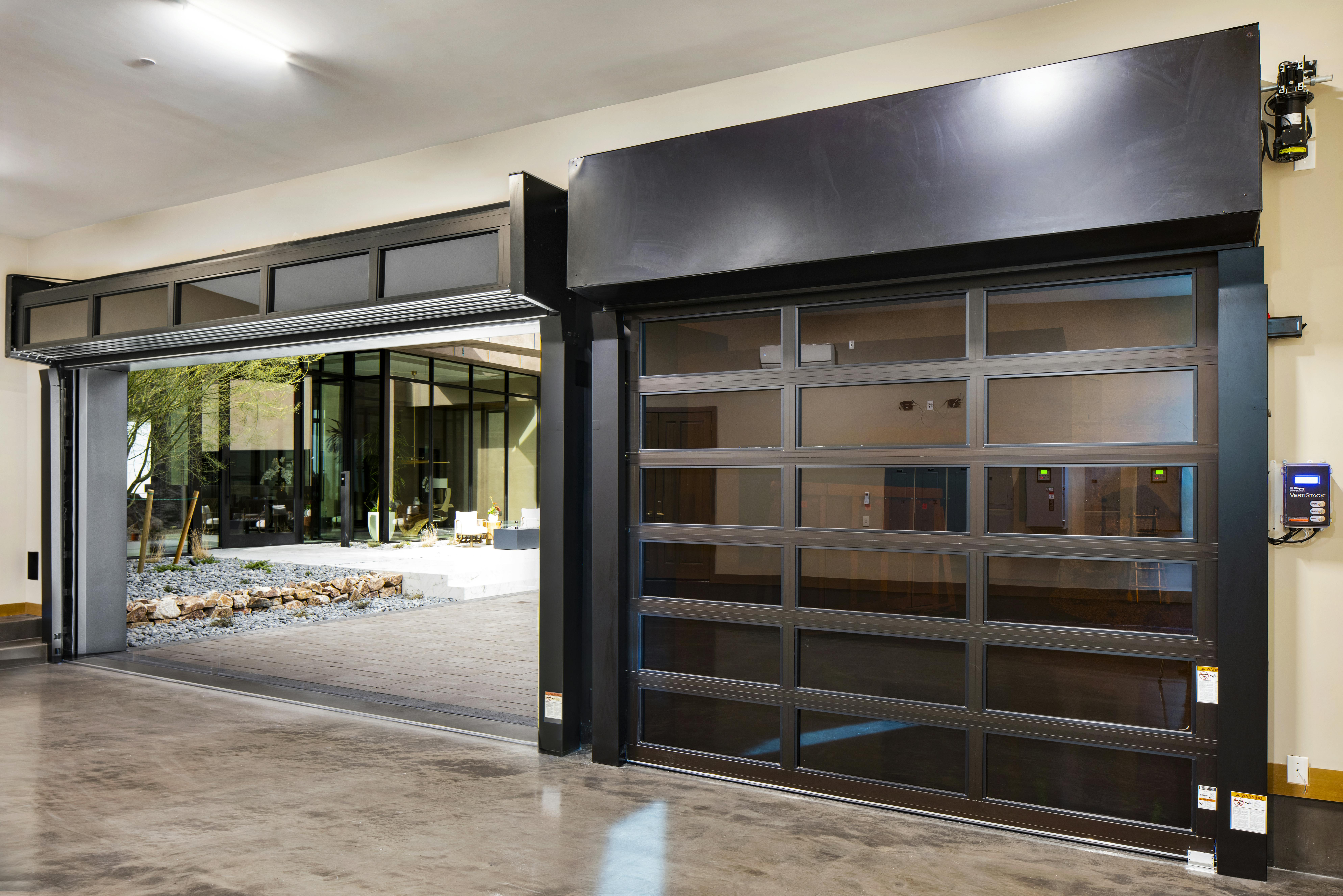 The VertiStack Avante Aluminum and Glass Garage Door from Clopay installed in The New American Home 2025