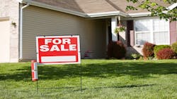 A home with a 'For Sale' sign in the front yard A home with a 'For Sale' sign in the front yard