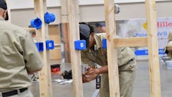 Students work at installing electrical outlets at a trade school Students work at installing electrical outlets at a trade school