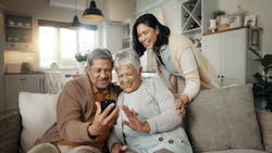 A woman and her parents chat with other family members on a video call A woman and her parents chat with other family members on a video call