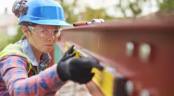 A woman works on a construction jobsite
