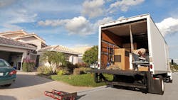 A moving truck parked outside of a home A moving truck parked outside of a home