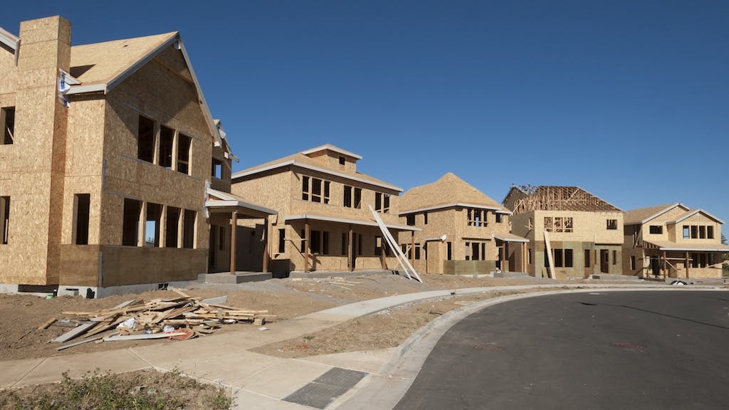 A row of single-family homes under construction